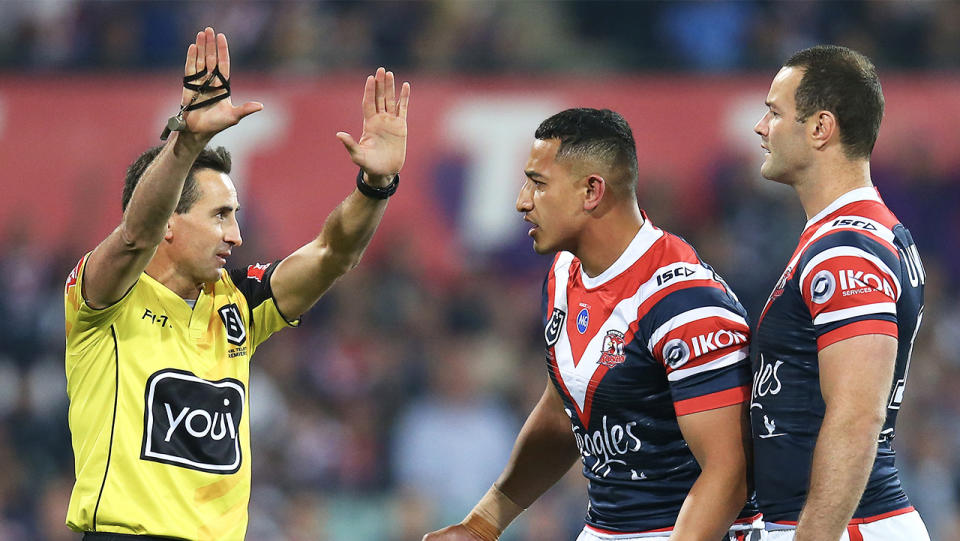  Siosiua Taukeiaho (pictured middle) of the Roosters is sent to the sin-bin by referee Gerard Sutton.