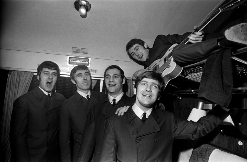 English rock band The Moody Blues pose for a photograph in a first class carriage on a train, 11th November 1964. Left to right : Ray Thomas, Clint Warwick, Mike Pinder, Graeme Edge, and Denny Laine (on shelf). (Photo by Robert Stiggins/Daily Express/Hulton Archive/Getty Images)