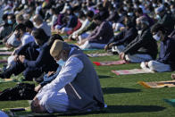 People participate in Eid al-Fitr prayers in Overpeck County Park in Ridgefield Park, N.J., Thursday, May 13, 2021. Millions of Muslims across the world are marking a muted and gloomy holiday of Eid al-Fitr, the end of the fasting month of Ramadan - a usually joyous three-day celebration that has been significantly toned down as coronavirus cases soar. (AP Photo/Seth Wenig)