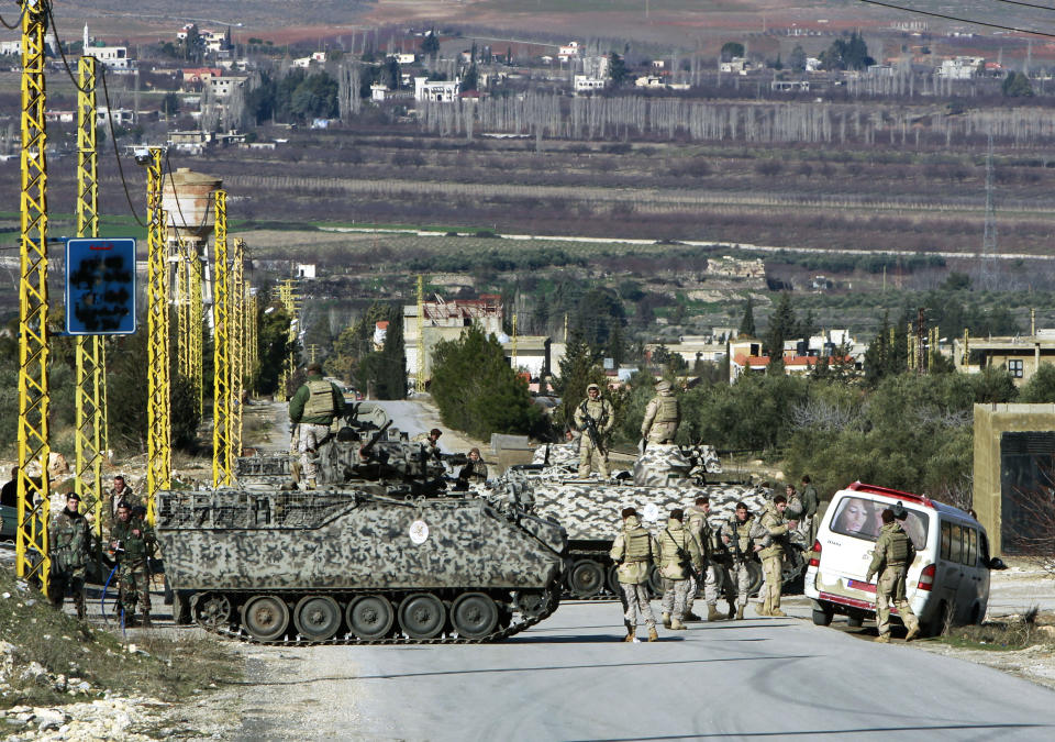 FILE - In this Saturday, Feb. 2, 2013 file photo, Lebanese army soldiers search civilians at a checkpoint for the entrance of Arsal, a Sunni Muslim town near the Syrian border in eastern Lebanon. A suicide bomber driving an explosives-laden car targeted a Lebanese army checkpoint near the Syrian border on Saturday, March 29, 2014, killing and wounding several soldiers, Lebanon's official news agency reported. (AP Photo/Bilal Hussein, File)