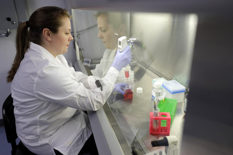 In this Wednesday, Jan. 15, 2020, photo scientist and study director Jennifer Molignano uses an electronic pipette to prepare culture medium, a dark pink fluid that provides nutrition to living human skin tissue, as she sets up a demonstration of experiments at a MatTek Corporation lab, in Ashland, Mass. Molignano demonstrated experiments created to evaluate the effects of exposing living human skin tissues to commercially available skin care products, as well as an experiment to evaluate the effects of ultraviolet B rays, a simulation of exposing skin tissues to sunlight. (AP Photo/Steven Senne)