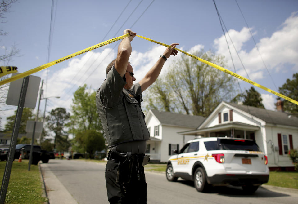 Law enforcement investigate the scene of a shooting, Wednesday, April 21, 2021 in Elizabeth City, N.C. At least one law enforcement officer with a sheriff's department in North Carolina shot and killed a man while executing a search warrant Wednesday, the sheriff's office said. (Stephen M. Katz/The Virginian-Pilot via AP)