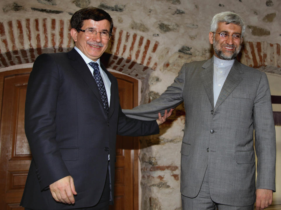 Turkey's Foreign Minister Ahmet Davutoglu, left, and Iran's Chief Nuclear Negotiator Saeed Jalili pose for cameras before their meeting in Istanbul, Turkey, Friday, April 13, 2012. After years of failure, Iran and the six world powers may finally make some progress on nuclear negotiations when they meet again Saturday if each side shows willingness to offer concessions the other seeks.(AP Photo/Burhan Ozbilici)