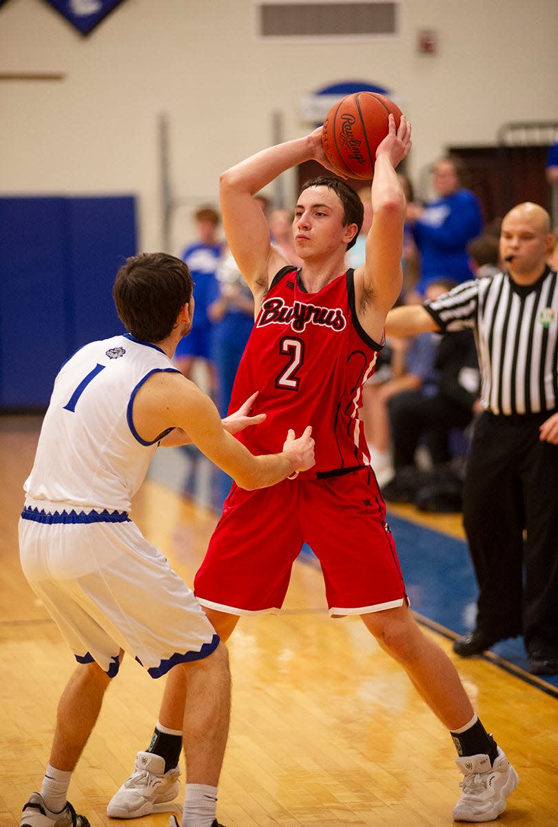 Bucyrus' Joe Rager looks to pass around Crestline's Conner Lusk.