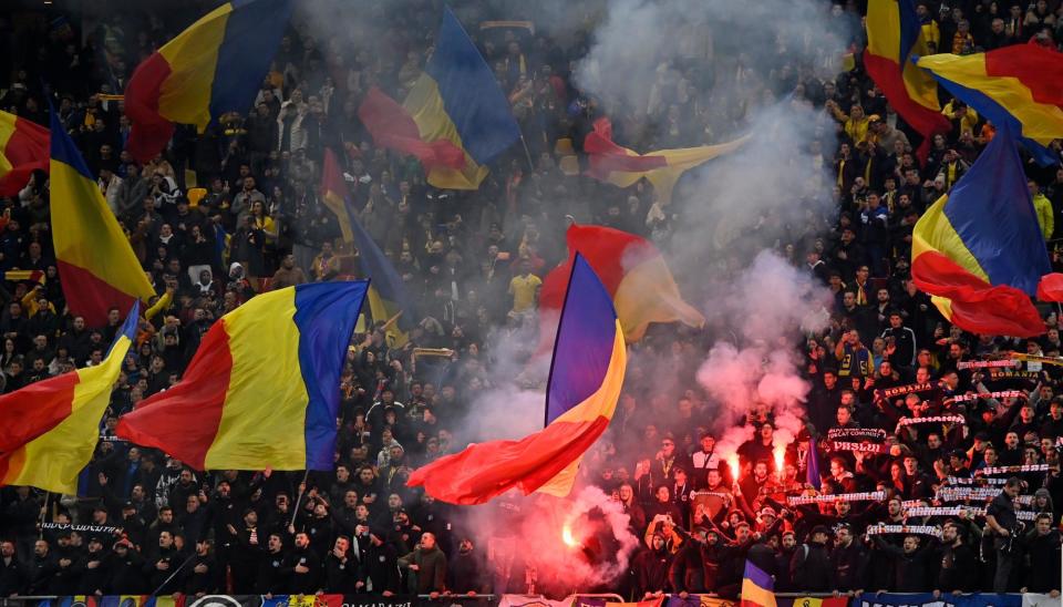 <span>Romania fans create the atmosphere during their side’s qualifer against Switzerland last November.</span><span>Photograph: Alex Nicodim/NurPhoto/Getty Images</span>