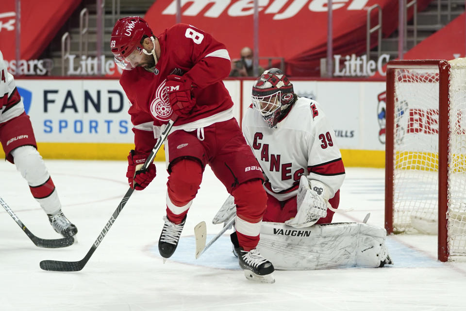 Detroit Red Wings center Sam Gagner (89) tries to redirect a shot on Carolina Hurricanes goaltender Alex Nedeljkovic (39) in the second period of an NHL hockey game Sunday, March 14, 2021, in Detroit. (AP Photo/Paul Sancya)