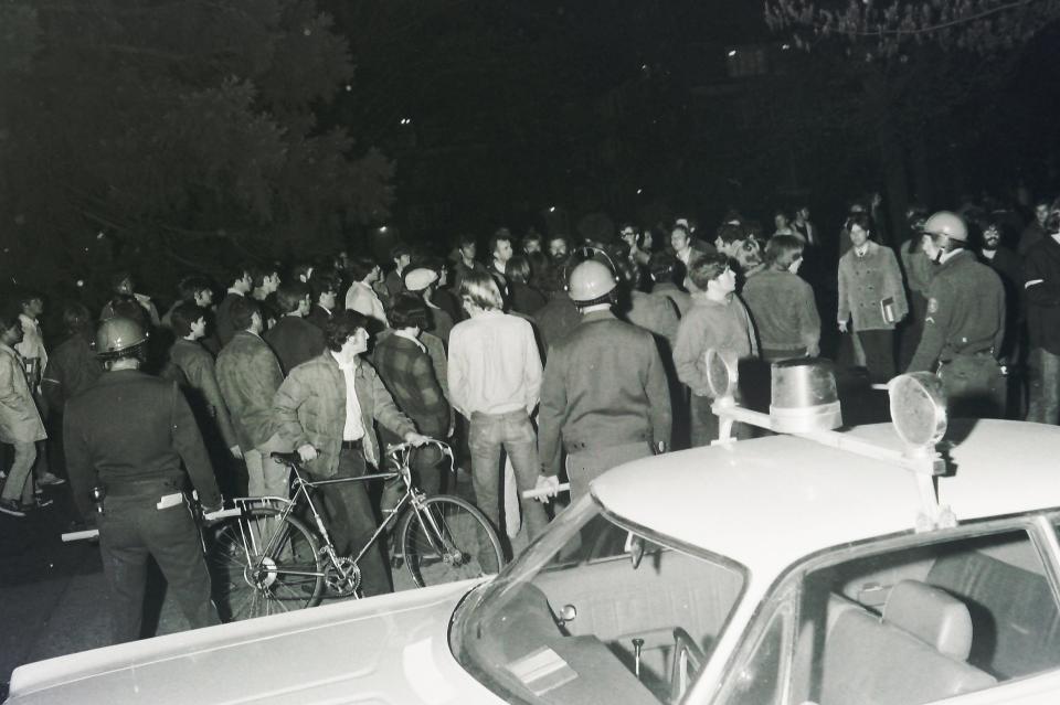 Eugene Police and other officers dressed in riot gear protect the Army ROTC offices on the University of Oregon campus during a protest in 1970.