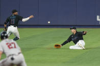 Miami Marlins shortstop Miguel Rojas (11) and right fielder Peyton Burdick scramble for a ball hit by Atlanta Braves' Robbie Grossman for a base hit, during the fourth inning of the first game of a baseball doubleheader, Saturday, Aug. 13, 2022, in Miami. (AP Photo/Wilfredo Lee)