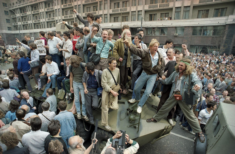 FILE - A crowd gathers around a personnel carrier as some people climb aboard the vehicle and try to block its advance near Red Square in downtown Moscow, Russia, on Aug. 19, 1991. The August 1991 coup that briefly ousted Soviet leader Mikhail Gorbachev collapsed in just three days, precipitating the breakup of the Soviet Union that plotters said they were trying to prevent. Former Soviet leader Gorbachev has died Tuesday Aug. 30, 2022 at a Moscow hospital at age 91. (AP Photo/Boris Yurchenko, File)