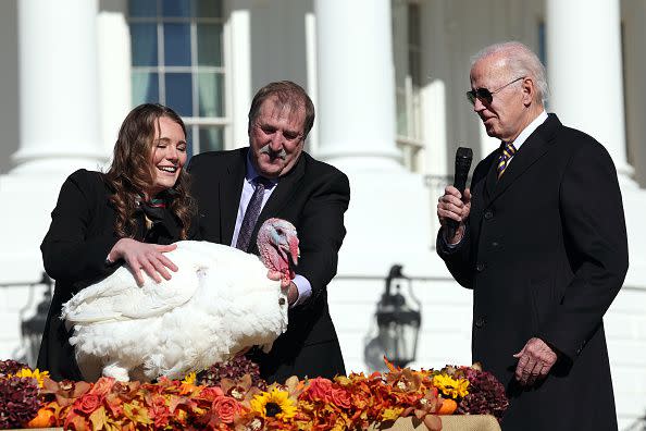 WASHINGTON, DC - NOVEMBER 21: U.S. President Joe Biden pardons Chocolate, the National Thanksgiving Turkey, as he is joined by the 2022 National Turkey Federation Chairman Ronnie Parker and Alexa Starnes, daughter of the owner of Circle S Ranch, on the South Lawn of the White House November 21, 2022 in Washington, DC. Chocolate, and the alternate, Chip, were raised at Circle S. Ranch, outside of Charlotte, North Carolina, and will reside on the campus of North Carolina State University following today's ceremony. (Photo by Win McNamee/Getty Images)