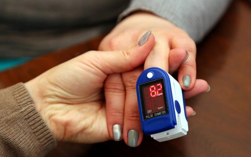 A patient has her blood oxygen saturation level measured ahead of receiving the coronavirus vaccine in Ukraine - Valentin Sprinchak /TASS