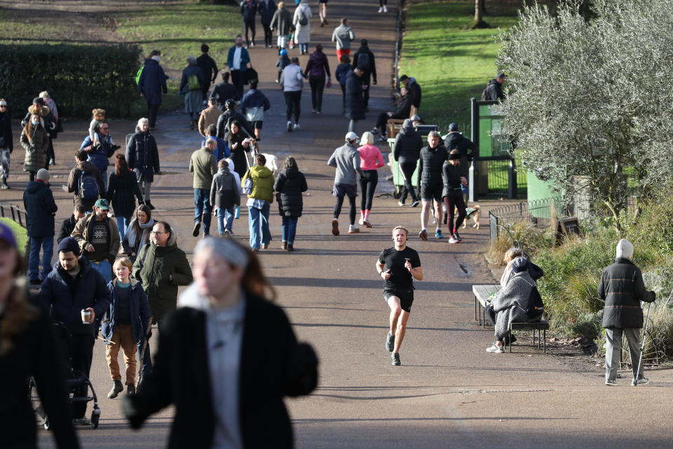 People walk in Hyde Park, London, during England's third national lockdown to curb the spread of coronavirus.