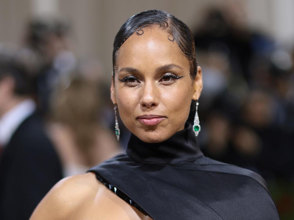 Alicia Keys in a black top and dangling earrings