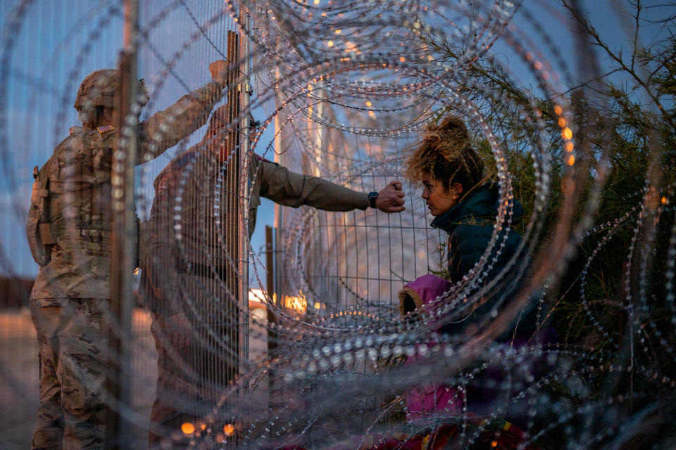 EL PASO, TEXAS - MARCH 26: Eliana, 22, a migrant from Venezuela, holds her daughter Crismarlees, 3, while being denied entry after attempting to cross through concertina from the U.S. side of the Rio Grande river on March 26, 2024 in El Paso, Texas. Four days ago, hundreds of migrants seeking asylum clashed with Texas national guardsmen while waiting to turn themselves in to border patrol agents for processing. Texas continues awaiting a verdict on Senate Bill 4. The bill allows state law enforcement officials to detain and arrest migrants suspected of illegally crossing into the U.S. Hours after the U.S. Supreme Court authorized Senate Bill 4, a federal appeals court halted the decision based on an earlier injunction. The politics and controversies surrounding border and immigration issues continue to be a dominant theme in the U.S. presidential election campaign. (Photo by Brandon Bell/Getty Images)