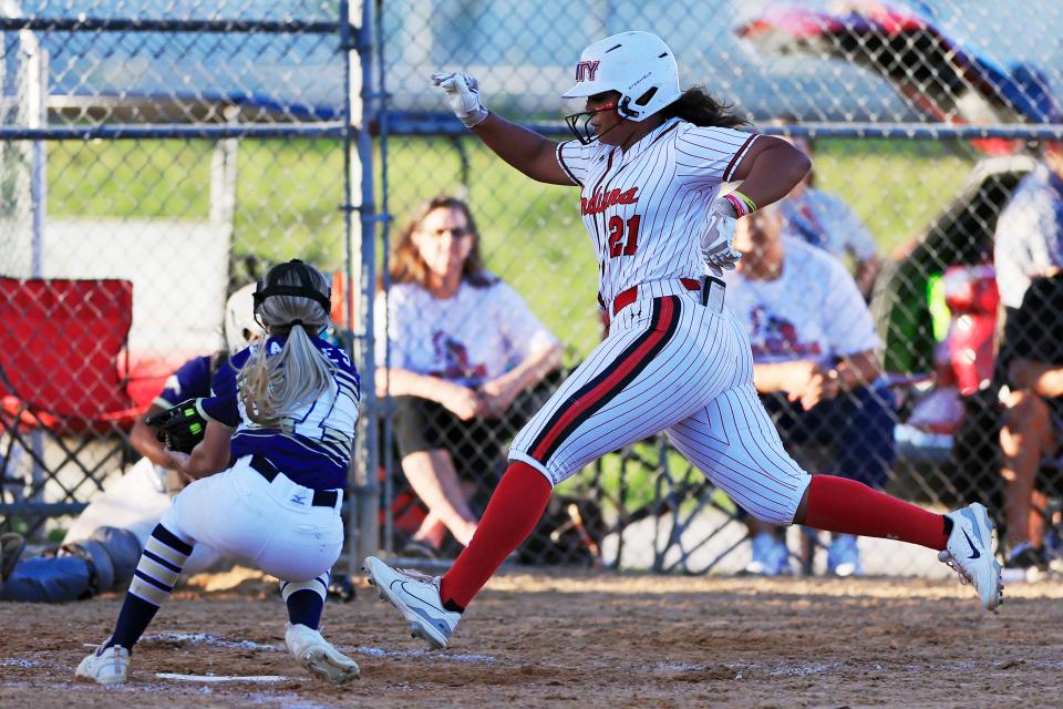 Baldwin's Jazmine Ramos-Merced (21) crosses the plate against Paxon in the 2023 Gateway Conference championship.