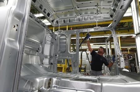 A man works at the assembly line in the truck production plant of truck and bus-maker MAN AG in Munich, Germany July 30, 2015. REUTERS/Michaela Rehle