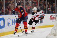 SUNRISE, FL - APRIL 26: Sean Bergenheim #20 of the Florida Panthers skates with the puck behind the net while being pursued by Peter Harrold #10 of the New Jersey Devils in Game Seven of the Eastern Conference Quarterfinals during the 2012 NHL Stanley Cup Playoffs at the BankAtlantic Center on April 26, 2012 in Sunrise, Florida. (Photo by Joel Auerbach/Getty Images)