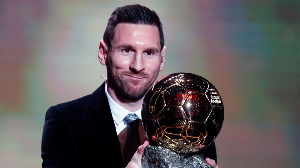 Lionel Messi smiling after winning a record sixth Ballon D'or award.