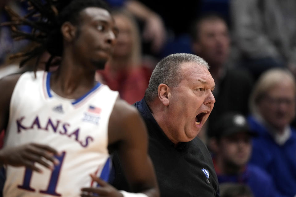 Eastern Illinois head coach Marty Simmons talks to his players during the first half of an NCAA college basketball game against Kansas Tuesday, Nov. 28, 2023, in Lawrence, Kan. (AP Photo/Charlie Riedel)