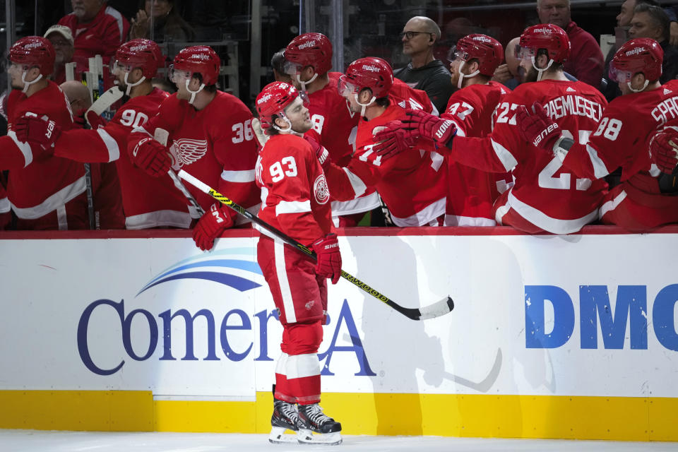 Detroit Red Wings right wing Alex DeBrincat (93) celebrates his goal against the Pittsburgh Penguins in the first period of an NHL hockey game Wednesday, Oct. 18, 2023, in Detroit. (AP Photo/Paul Sancya)