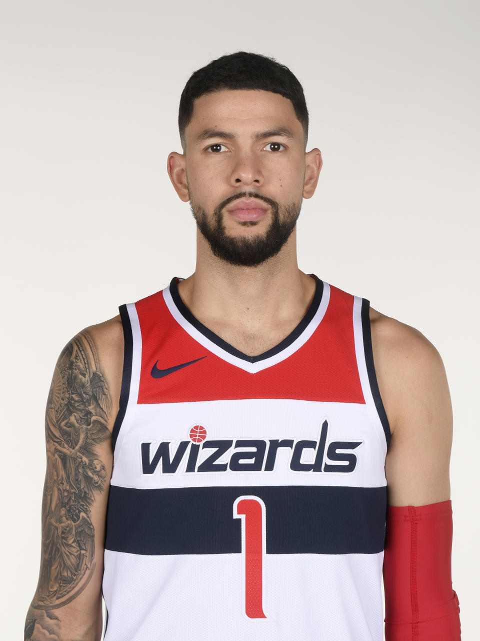 File-This photo taken Sept. 24, 2018, shows Washington Wizards' Austin Rivers poses for a photograph during an NBA basketball media day, in Washington. A person familiar with the deal says the Washington Wizards have an agreement in principle to acquire Trevor Ariza from the Phoenix Suns for Oubre Jr. and Austin Rivers. The person spoke to The Associated Press on condition of anonymity Saturday, Dec. 15, 2018, because it had not been announced by either team.(AP Photo/Nick Wass, File)