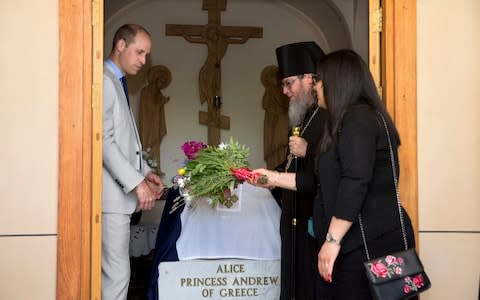  Prince William, left, visits the grave of his great-grandmother Princess Alice of Battenberg - Credit: Sebastian Scheiner /AP