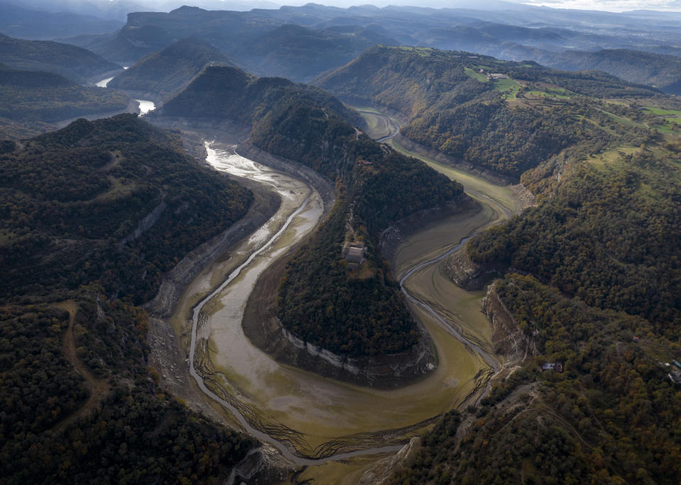 A view of Ter river running dry toward a reservoir near Vilanova de Sau, Catalonia, Spain, Wednesday, Nov. 23, 2022. (AP Photo/Emilio Morenatti)