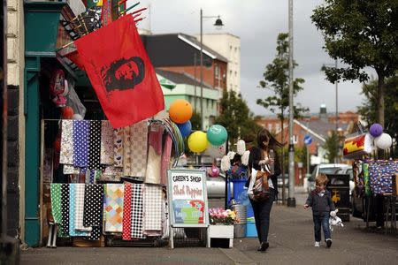 A flag bearing the image of Che Guevara hangs from a shop on the Nationalist Falls road in West Belfast August 18, 2014. REUTERS/Cathal McNaughton