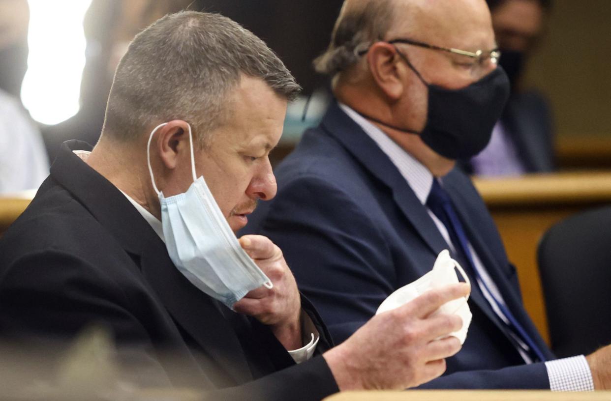 Paul Flores puts on a new N95 mask Aug. 3, 2021, at a preliminary hearing in San Luis Obispo, Calif. 