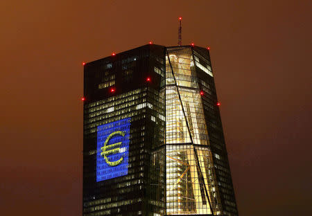 The headquarters of the European Central Bank (ECB) are illuminated with a giant euro sign at the start of the "Luminale, light and building" event in Frankfurt, Germany, March 12, 2016. REUTERS/Kai Pfaffenbach/File Photo