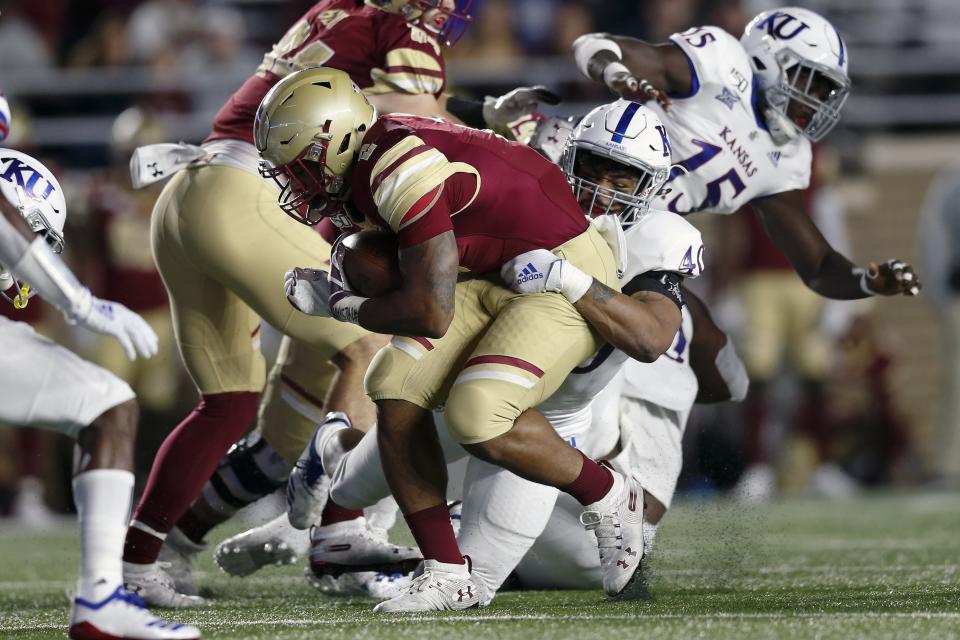 Kansas linebacker Dru Prox (40) tackles Boston College running back AJ Dillon (2) during the first half of an NCAA college football game in Boston, Friday, Sept. 13, 2019. (AP Photo/Michael Dwyer)