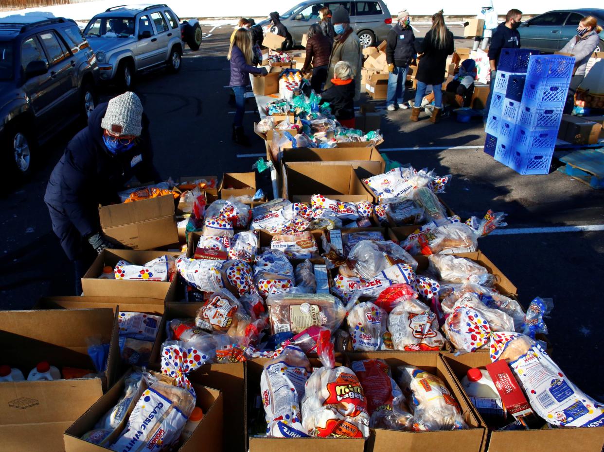 People line up in their cars in the parking lot of St. James Presbyterian Church in Littleton, Colorado to receive food donations from Food Bank of the Rockies ahead of Thanksgiving (REUTERS)