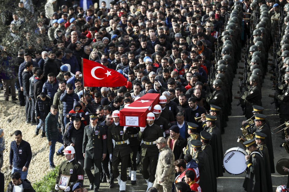 FILE - In this Feb. 29, 2020 file photo, An honour guard carries the coffin of Muhammed Ali Ozer, one of the 36 Turkish soldiers killed on Thursday in a Syrian army attack in the Idlib area of Syria, in Hatay, Turkey. In a world gripped by a pandemic, global unrest and a fast-moving news cycle, it can be difficult to remember that the war in Syria is still happening. (AP Photo/ File)