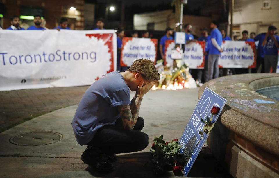 A man reacts at a vigil in remembrance of the victims of a shooting the evening before, in Toronto, Monday, July 23, 2018. (Mark Blinch/The Canadian Press via AP)