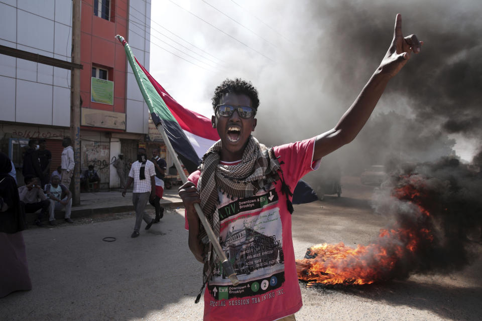 A man chants slogans during a protest to denounce the October military coup, in Khartoum, Sudan, Saturday, Dec. 25, 2021. Sudanese security forces fired tear gas to disperse protesters as thousands rallied since earlier in the day, even as authorities tightened security across Khartoum, deploying troops and closing all bridges over the Nile River linking the capital with its twin city of Omdurman and the district of Bahri, the state-run SUNA news agency reported.(AP Photo/Marwan Ali)