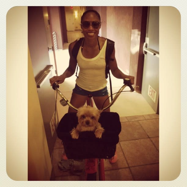 Track & Field star Allyson Felix about to take a bike ride with her dog Chloe.