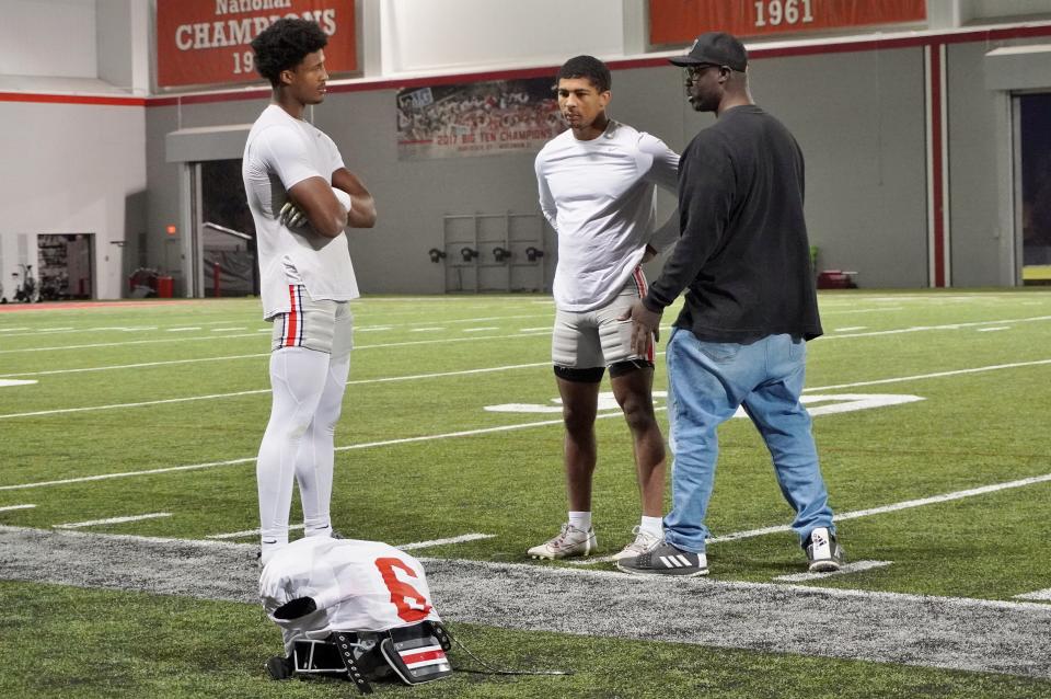 Ohio State safety Sonny Styles (left) talks with his dad Lorenzo Sr. and brother Lorenzo Jr. after a practice on Nov. 15.