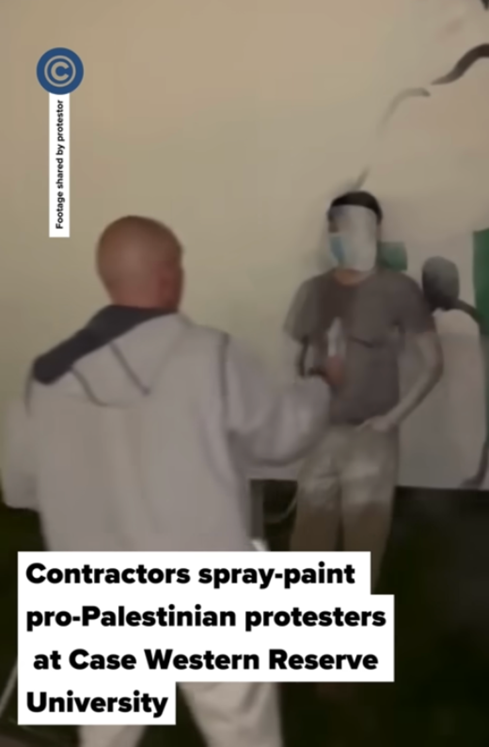 A contractor hired by Case Western Reserve University paints over a pro-Palestinian protester on 7 May. The next day, anti-war protesters occupied an administrative building on campus (cleveland.com)