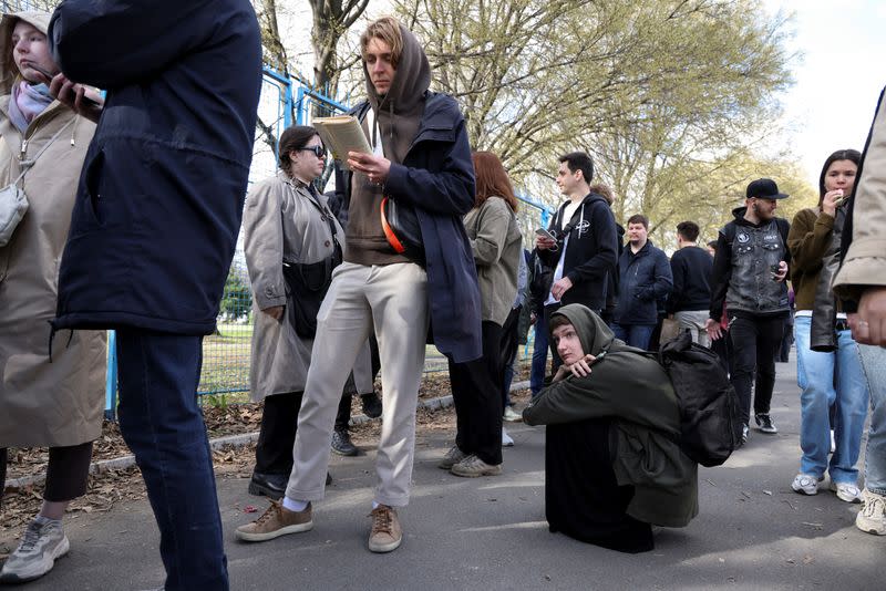 Russian citizens stand in long lines to vote on the last day of the presidential elections