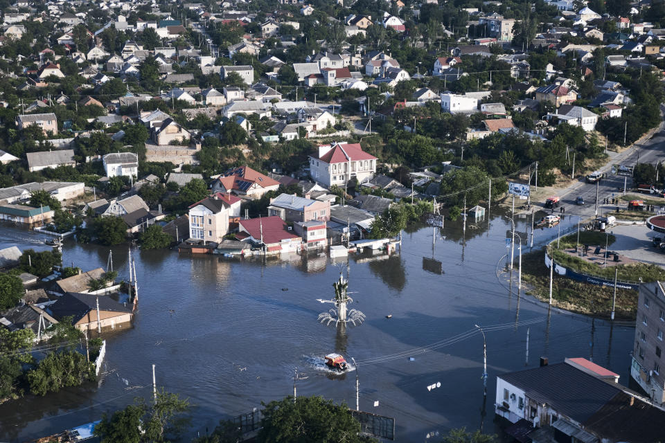 Streets are flooded in Kherson, Ukraine, Wednesday, June 7, 2023 after the walls of the Kakhovka dam collapsed. Residents of southern Ukraine, some who spent the night on rooftops, braced for a second day of swelling floodwaters on Wednesday as authorities warned that a Dnieper River dam breach would continue to unleash pent-up waters from a giant reservoir. (AP Photo/Libkos)