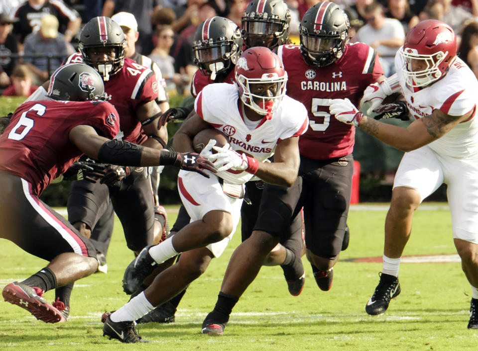 COLUMBIA, SC – OCTOBER 7: Running back TJ Hammonds #6 of the Arkansas Razorbacks tries to elude a tackle by linebacker TJ Brunson #6 of the <a class="link " href="https://sports.yahoo.com/ncaaw/teams/south-carolina/" data-i13n="sec:content-canvas;subsec:anchor_text;elm:context_link" data-ylk="slk:South Carolina Gamecocks;sec:content-canvas;subsec:anchor_text;elm:context_link;itc:0">South Carolina Gamecocks</a> at Williams-Brice Stadium on October 7, 2017 in Columbia, South Carolina. (Photo by Todd Bennett/GettyImages)