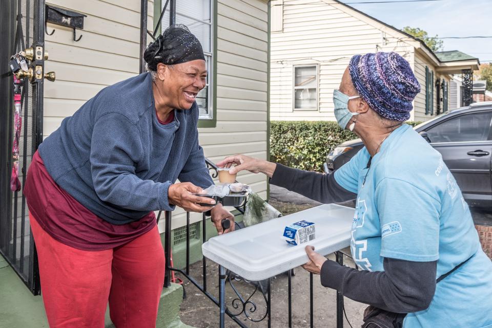 Vickie Melvin receives her Meals on Wheels lunch from MIFA volunteer Michele Riolo. Memphis leads the nation in elderly food insecurity, a situation that reflects the area's structural poverty.