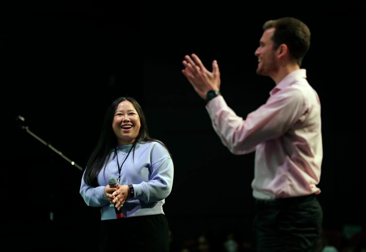 Singer Maa Vue, left, and music teacher Luke Aumann react after Appleton North High School's choir performed one of Vue’s original songs during a rehearsal for the upcoming “Mirrors and Windows” concert on May 10, 2024, in Appleton, Wisconsin.