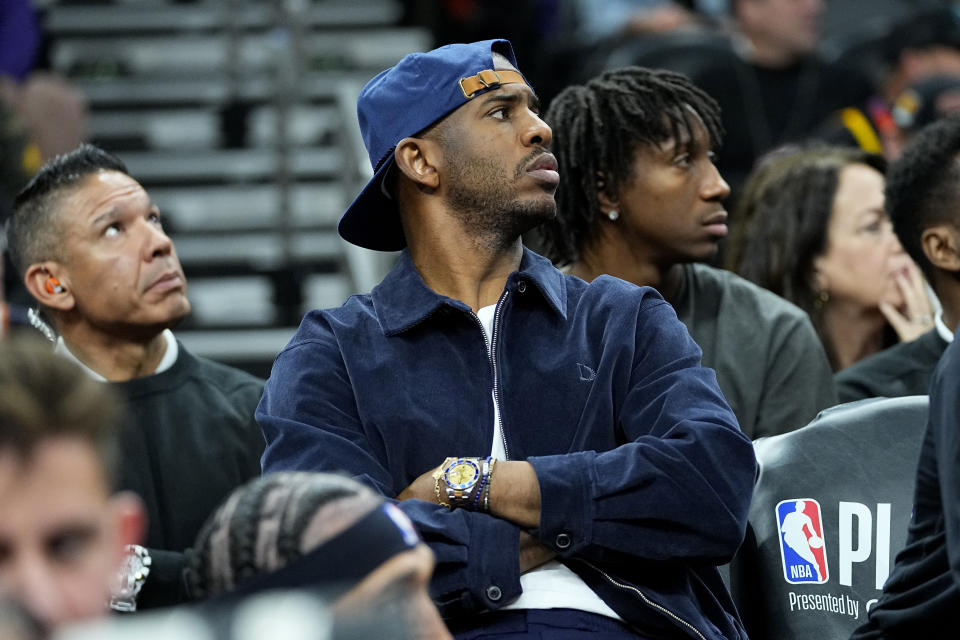 Phoenix Suns guard Chris Paul watches from the bench during the second half of Game 6 of an NBA basketball Western Conference semifinal series against the Denver Nuggets, Thursday, May 11, 2023, in Phoenix. The Nuggets eliminated the Sun in their 125-100 win. (AP Photo/Matt York)