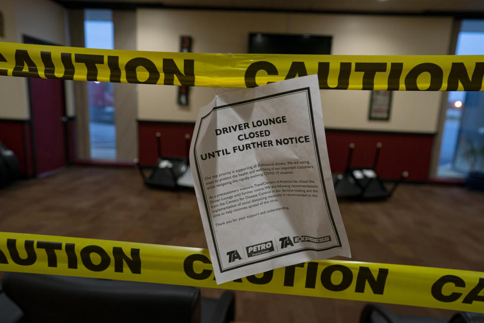 In this April 4, 2020, photo, the drivers lounge with a television and chairs is closed with yellow caution tape at the TA Travel Center truck stop in Foristell, Mo. The need for social distancing because of the coronavirus outbreak has closed lounges and other areas where truckers socialize and relax during a stop. (AP Photo/Carolyn Kaster)