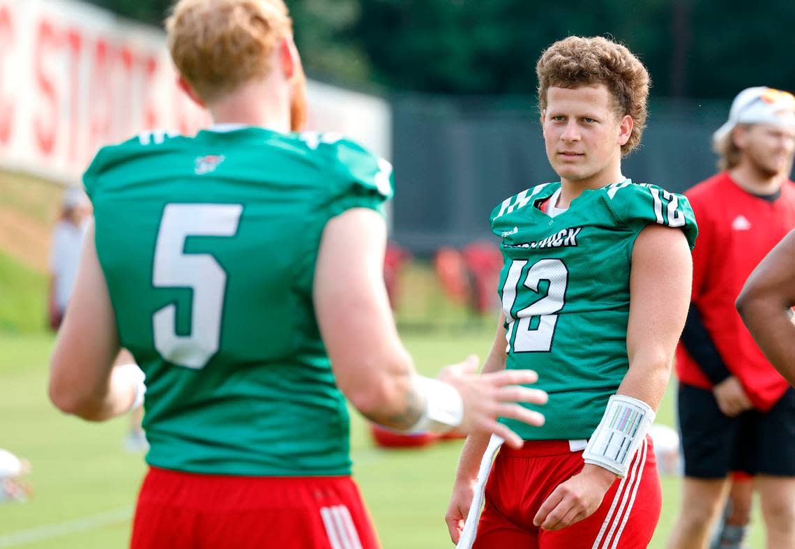 N.C. State quarterback Brennan Armstrong (5) talks with quarterback Lex Thomas (12) during the Wolfpack’s first fall practice in Raleigh, N.C., Wednesday, August 2, 2023. Ethan Hyman/ehyman@newsobserver.com