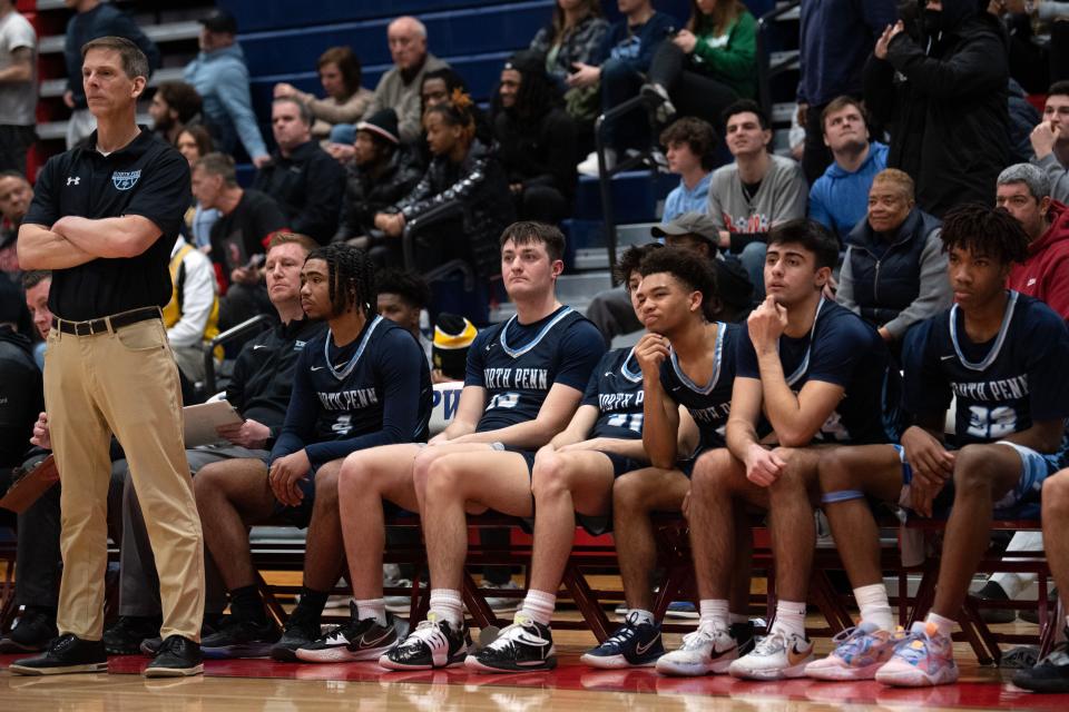 North Penn boys basketball head coach John Conrad, far left, and his players watch the action during a PIAA District One Class 6A quarterfinal loss to eventual champion Plymouth Whitemarsh.