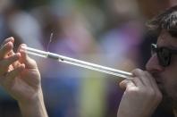 A competitor loads his pea shooter during the 2014 World Pea Shooting Championship in Witcham, southern England July 12, 2014. The annual competition has been held in the village since 1971 and attracts participants from across the globe.