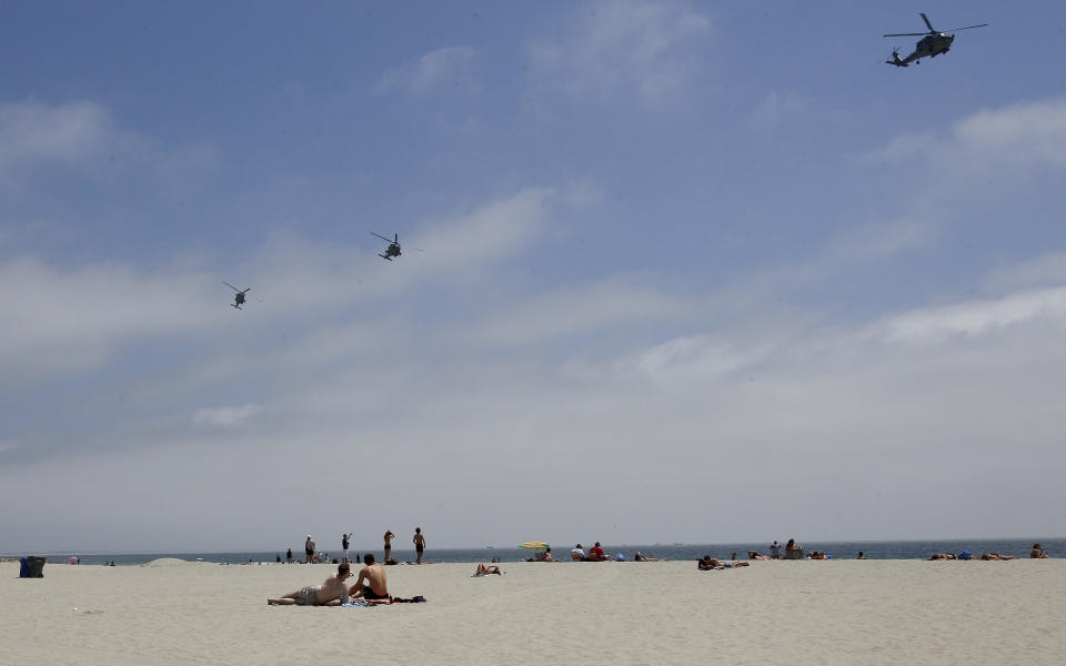 In this May 22, 2012 photo, part of a Navy helicopter squadron flies over beach goers on the Coronado Beach in Coronado, Calif. The Coronado Beach has been named America's best beach. Coronado Beach tops the 2012 list of Top 10 Beaches produced annually by coastal expert Stephen P. Leatherman, also known as "Dr. Beach," director of Florida International University's Laboratory for Coastal Research. (AP Photo/Lenny Ignelzi)