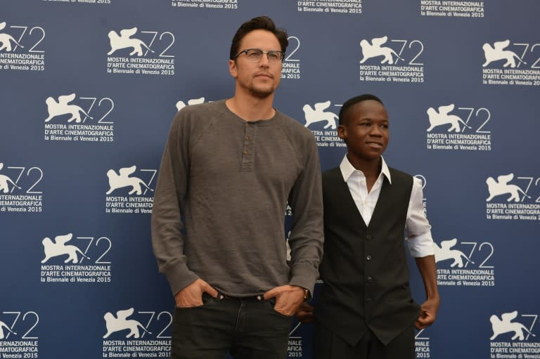 US director Cary Fukunaga (L) and actor Abraham Attah pose during the photocall of the movie "Beasts of No Nation" presented in competition at the 72nd Venice International Film Festival on September 3, 2015 at Venice Lido